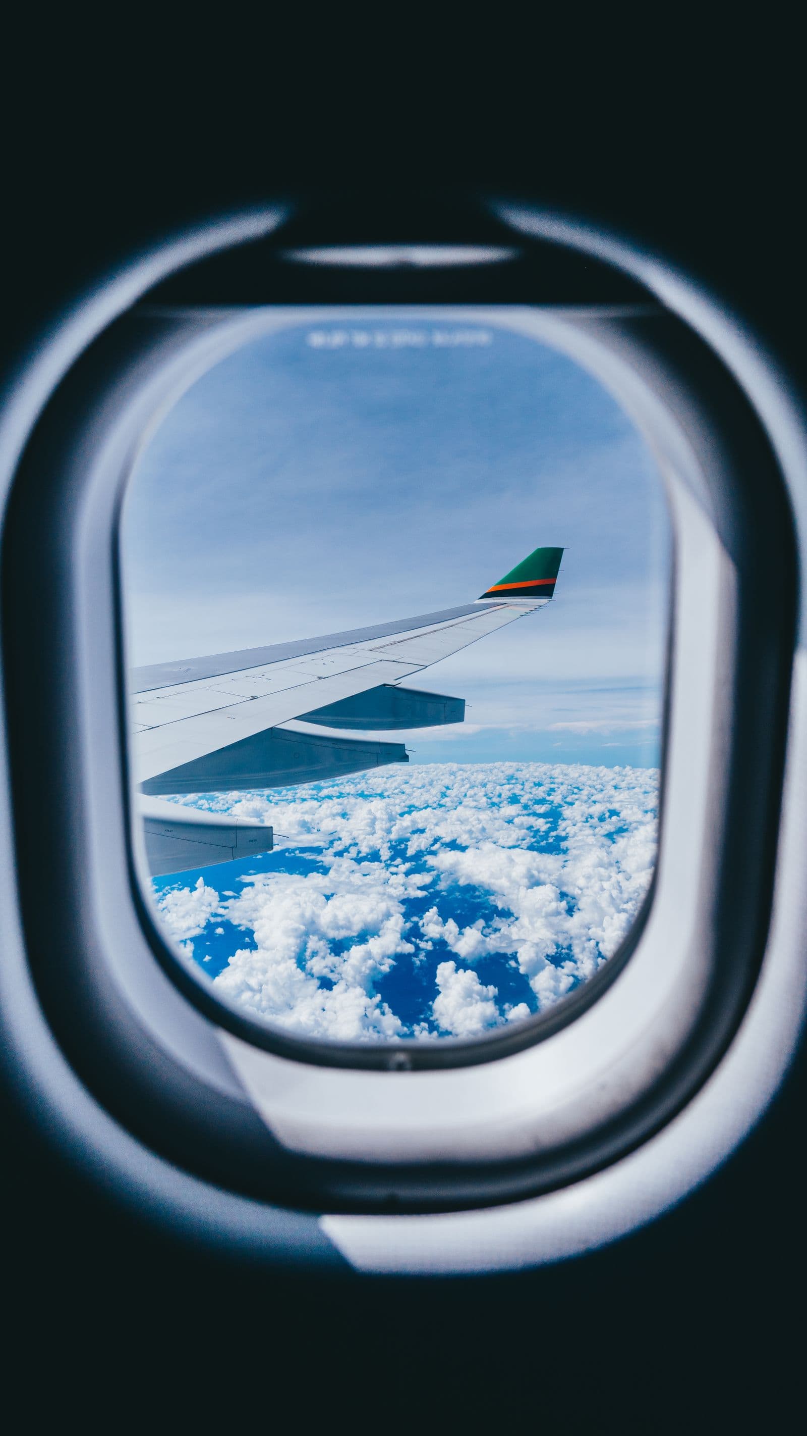 Airplane window view above the clouds